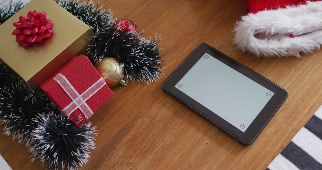 Festive Holiday Gifts and Digital Tablet on Wooden Table - Free Images, Stock Photos and Pictures on Pikwizard.com