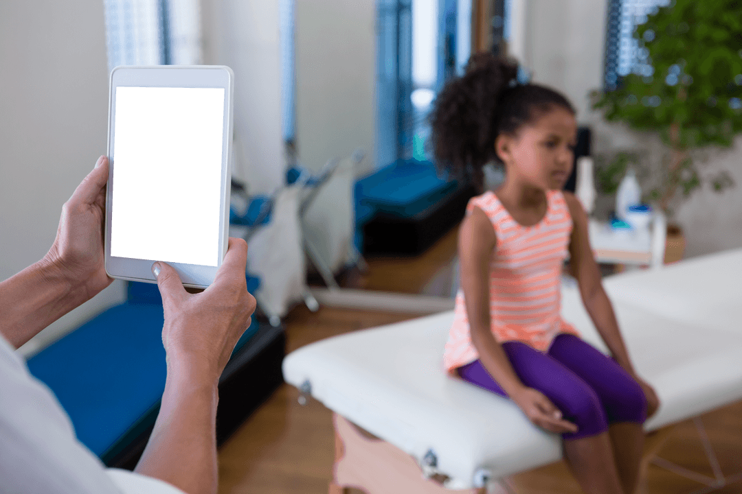 Physiotherapist Using Tablet with Child on Massage Table, Black Background Transparent