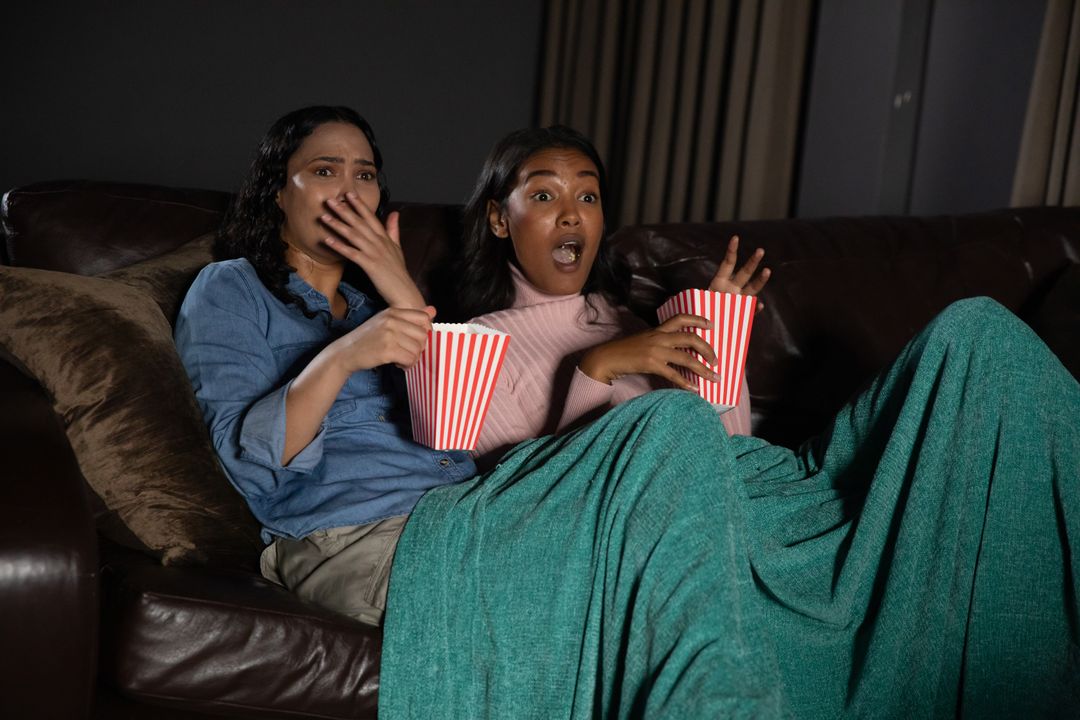 Diverse Friends Watching Movie with Enthralling Emotion