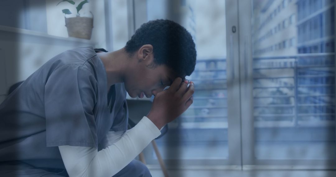 Stressed Healthcare Worker Pondering in Hospital Room