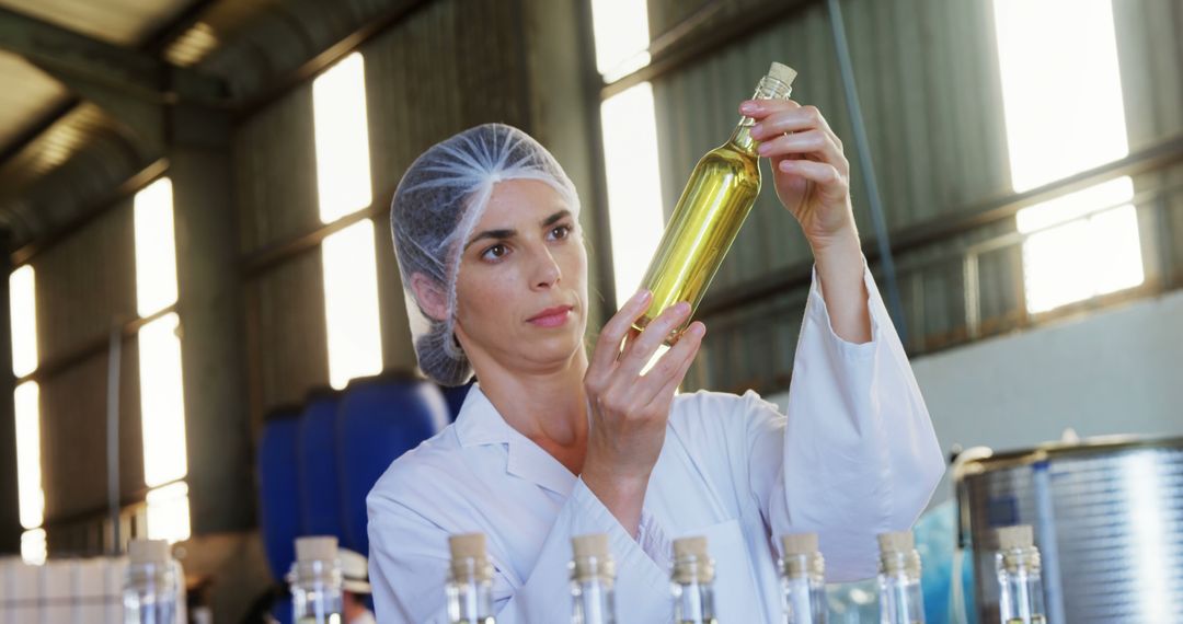 Female Quality Control Inspector Examining Oil Production in Factory - Free Images, Stock Photos and Pictures on Pikwizard.com