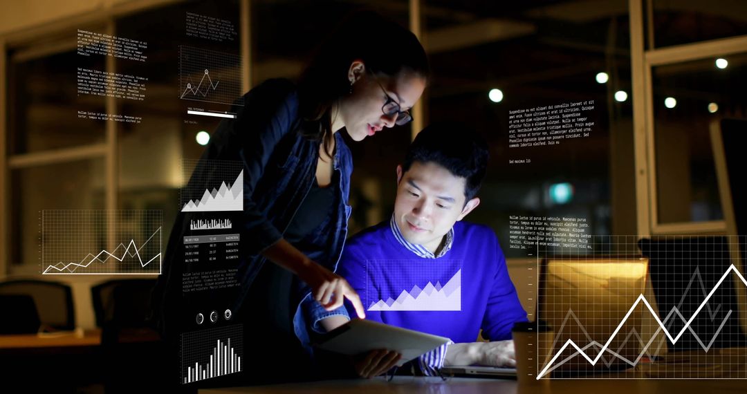 Analyzing Data on Digital Tablet in Night Office Meeting