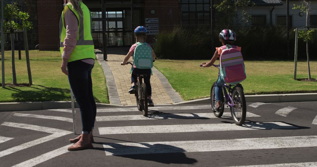 Children Crossing Road with Safety Guidance on Bikes