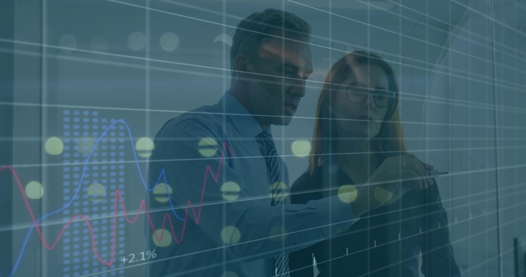 Business Professionals Analyzing Data on Transparent Board in Office