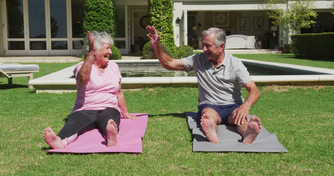 Senior Couple Doing Yoga Exercises in Backyard, High-Fiving - Free Images, Stock Photos and Pictures on Pikwizard.com