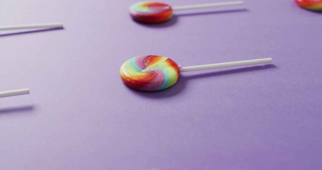 Colorful Swirl Lollipops on Purple Background - Free Images, Stock Photos and Pictures on Pikwizard.com