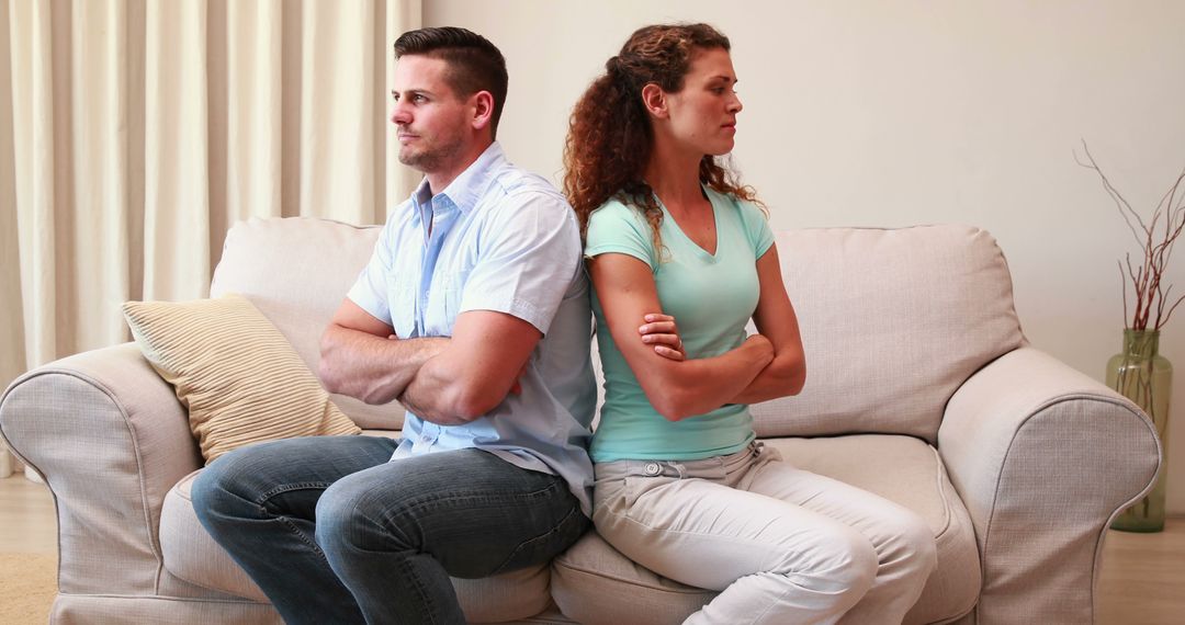 Young Couple Sitting Back to Back on Couch After Argument at Home - Free Images, Stock Photos and Pictures on Pikwizard.com