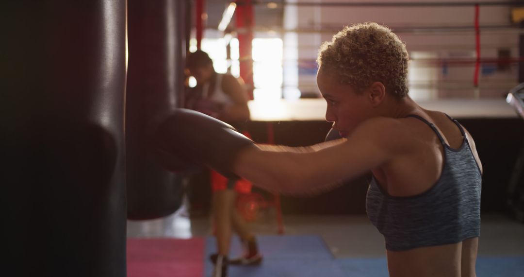 Strong Female Boxer Training at Boxing Gym