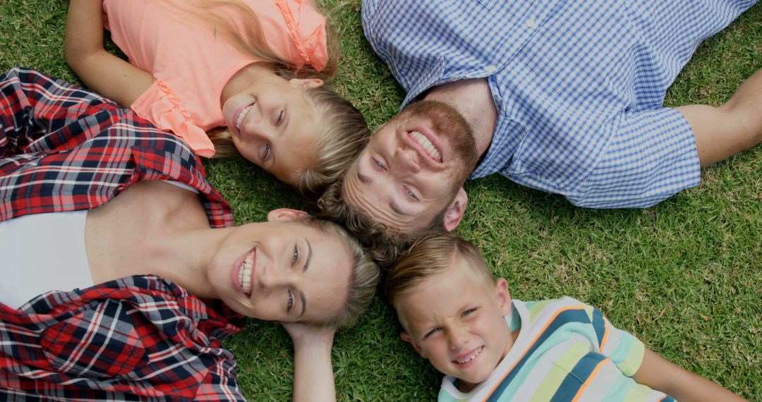 Happy Family Lying on Grass Smiling and Relaxing - Free Images, Stock Photos and Pictures on Pikwizard.com