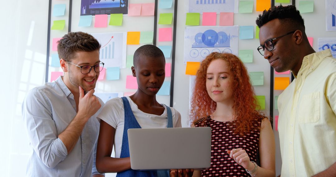 Diverse Friends Collaborating on Laptop for Creative Project