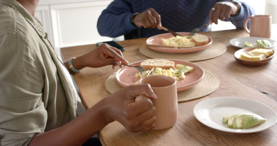 Couple Enjoying Breakfast with Scrambled Eggs and Avocado Toast