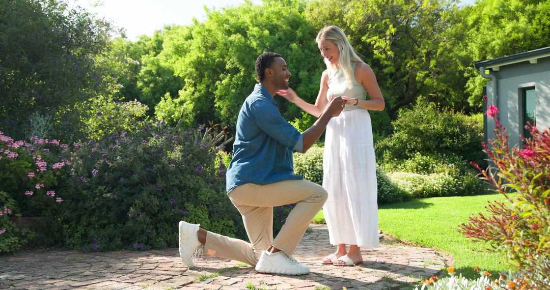 Joyful Marriage Proposal in Sunlit Garden Setting