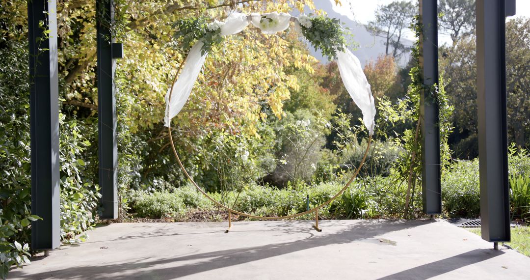 Outdoor Wedding Arch with Floral Decorations in Sunlit Garden - Free Images, Stock Photos and Pictures on Pikwizard.com