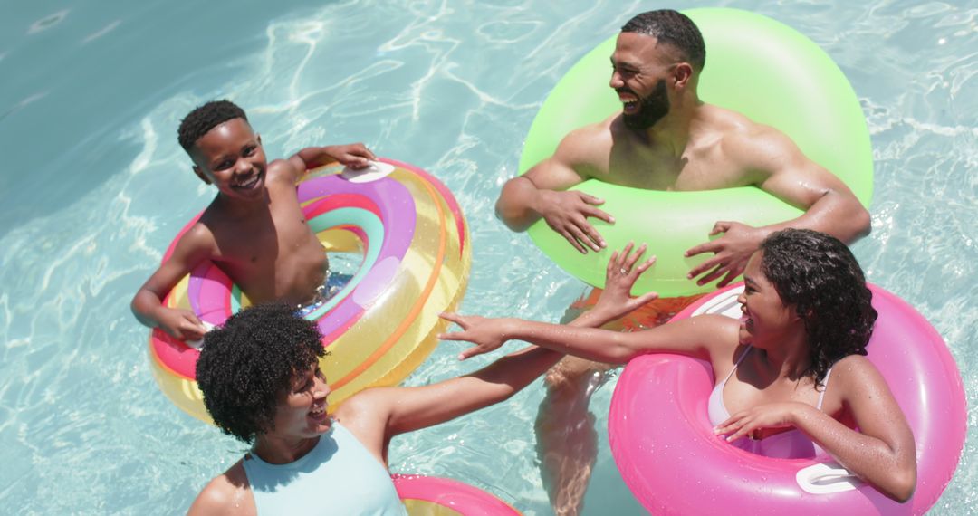 Happy Family Enjoying Pool Day with Colorful Inflatables