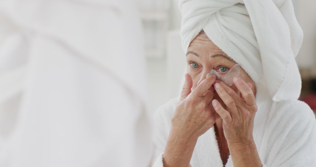 Senior Woman Applying Skincare Cream in Bathroom - Free Images, Stock Photos and Pictures on Pikwizard.com