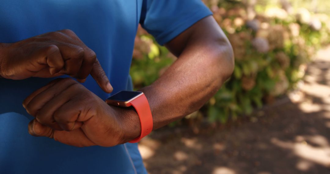 Man using smart watch during outdoor workout - Free Images, Stock Photos and Pictures on Pikwizard.com