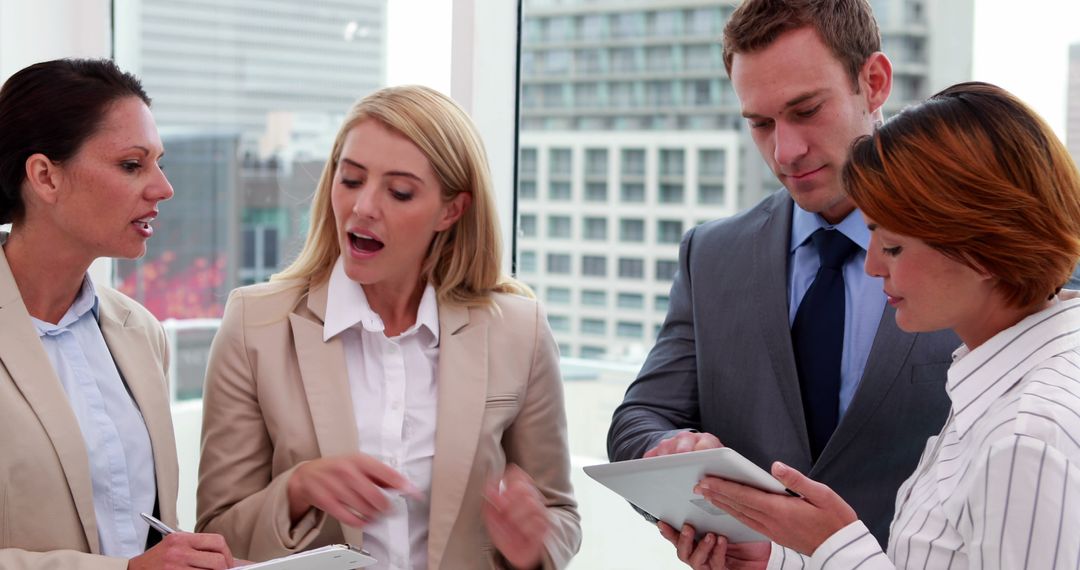Business Professionals Engaged in Office Meeting with Digital Devices