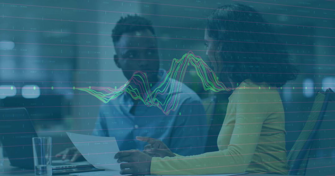 Professional Colleagues Analyzing Data with Graphic Overlay