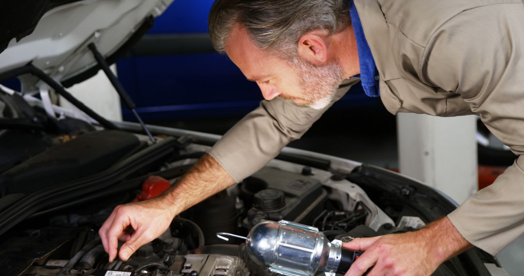 Mechanic Inspecting Car Engine at Vehicle Repair Shop - Free Images, Stock Photos and Pictures on Pikwizard.com