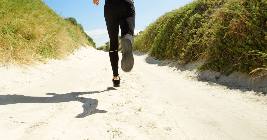 Woman Running on a Sandy Path in Nature for Active Lifestyle Concept