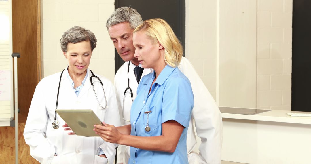 Medical Team Collaborating Using Digital Tablet - Free Images, Stock Photos and Pictures on Pikwizard.com