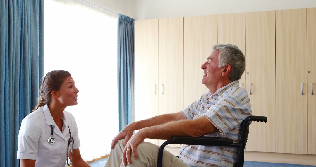 Nurse Attending to Elderly Patient in Wheelchair During Home Visit - Free Images, Stock Photos and Pictures on Pikwizard.com