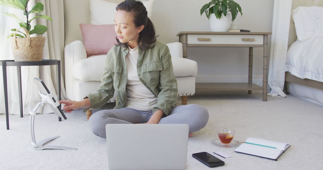 Asian Woman Remote Working with Laptop and Tablet at Home