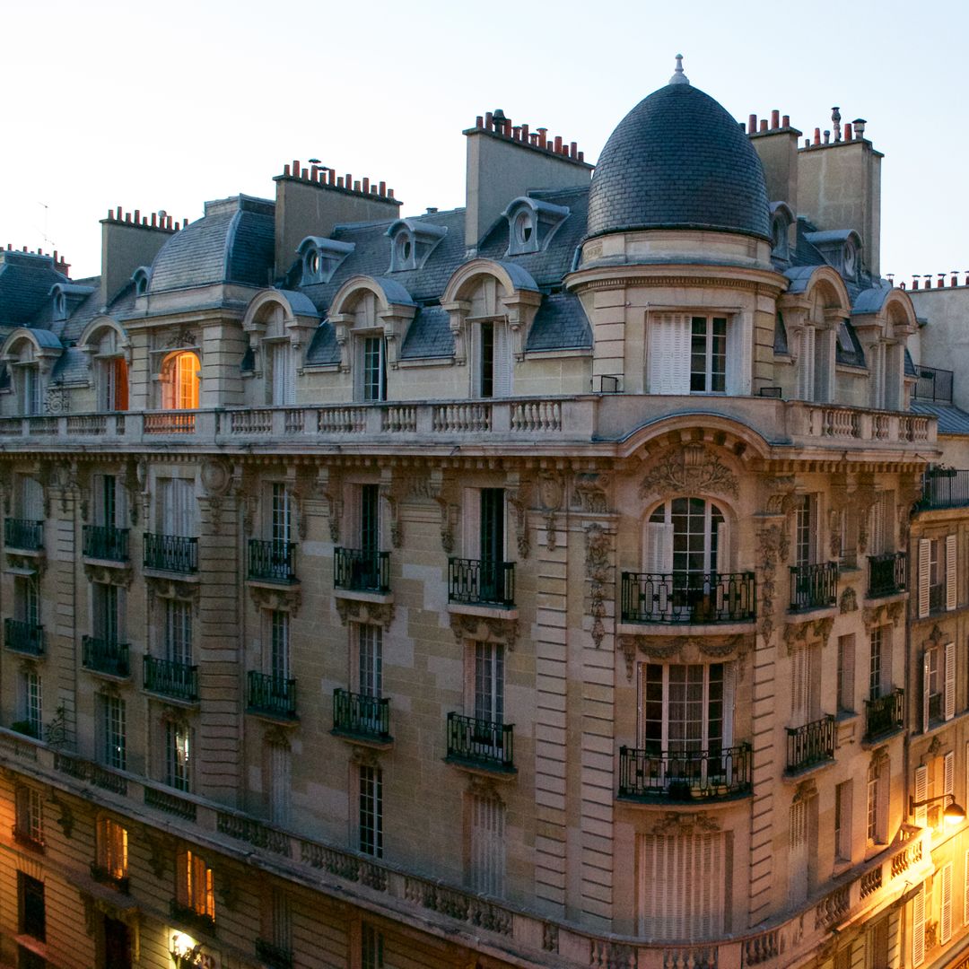 Elegant Parisian Apartment Building at Dusk - Free Images, Stock Photos and Pictures on Pikwizard.com
