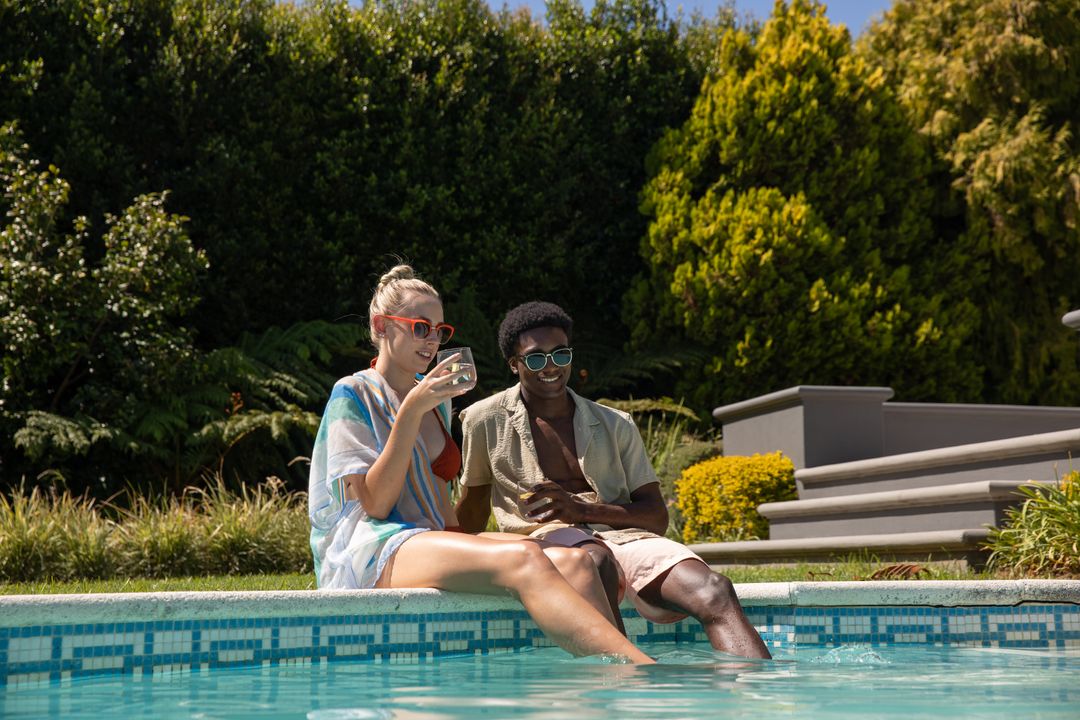 Couple Relaxing by Poolside Enjoying Refreshing Summer Drinks