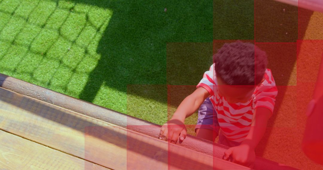Young Child Climbing Play Structure with Red Digital Interface Overlay