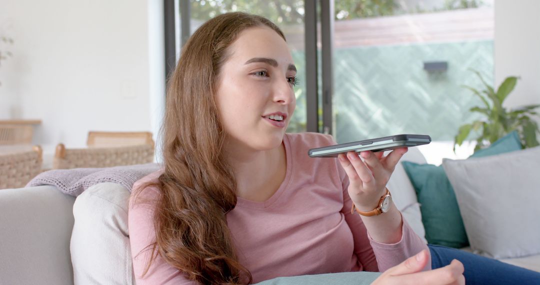 Young woman using voice command on tablet at home - Free Images, Stock Photos and Pictures on Pikwizard.com