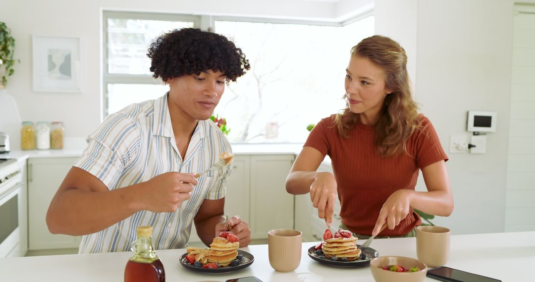 Couple Enjoying Breakfast with Pancakes in Modern Kitchen