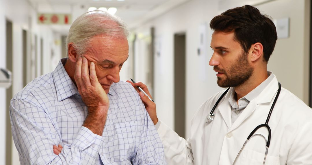 Doctor Consoling Senior Patient in Hospital Hallway - Free Images, Stock Photos and Pictures on Pikwizard.com