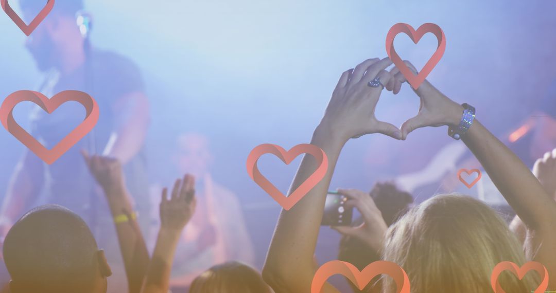 Crowd Celebrating at Concert with Heart Icons Digital Overlay