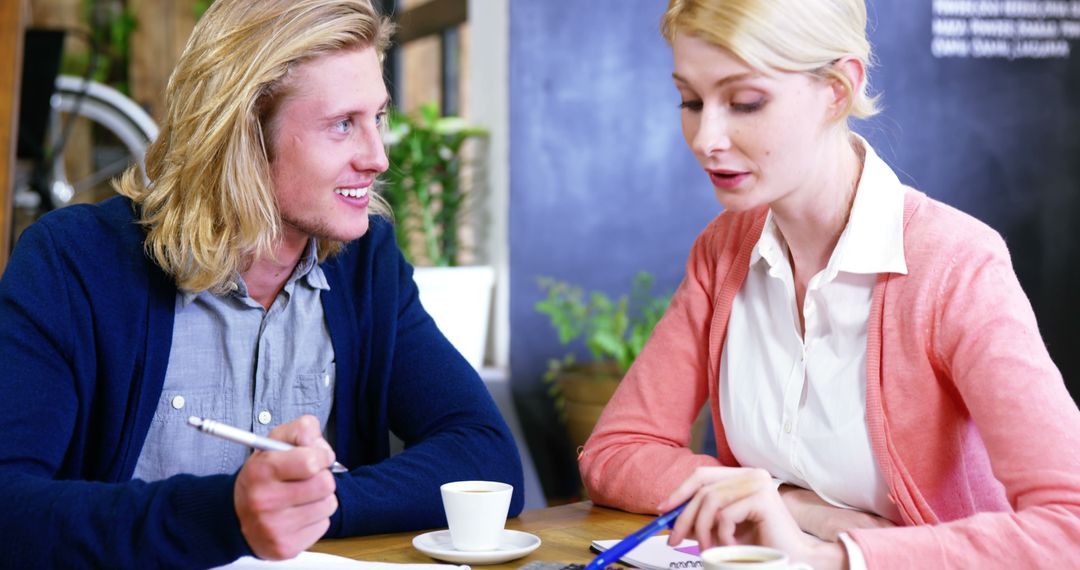 Colleagues Engaging in Discussion at Cafe