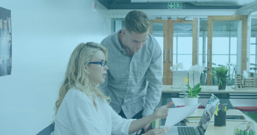 Business Team Reviewing Documents in Modern Office Setting
