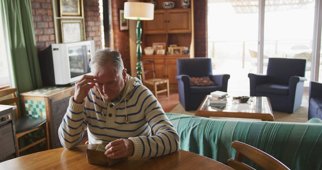 Elderly Man Reflecting Memories Holding Photograph at Home - Free Images, Stock Photos and Pictures on Pikwizard.com