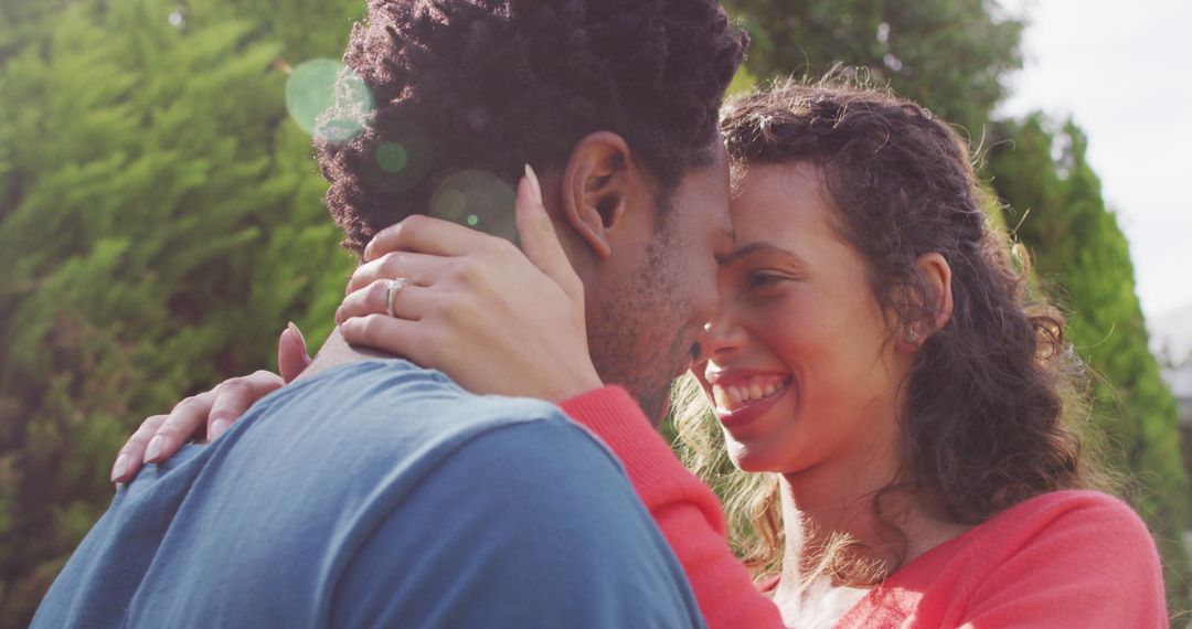 Joyful Couple Embraces in Romantic Engagement Moment Outdoors
