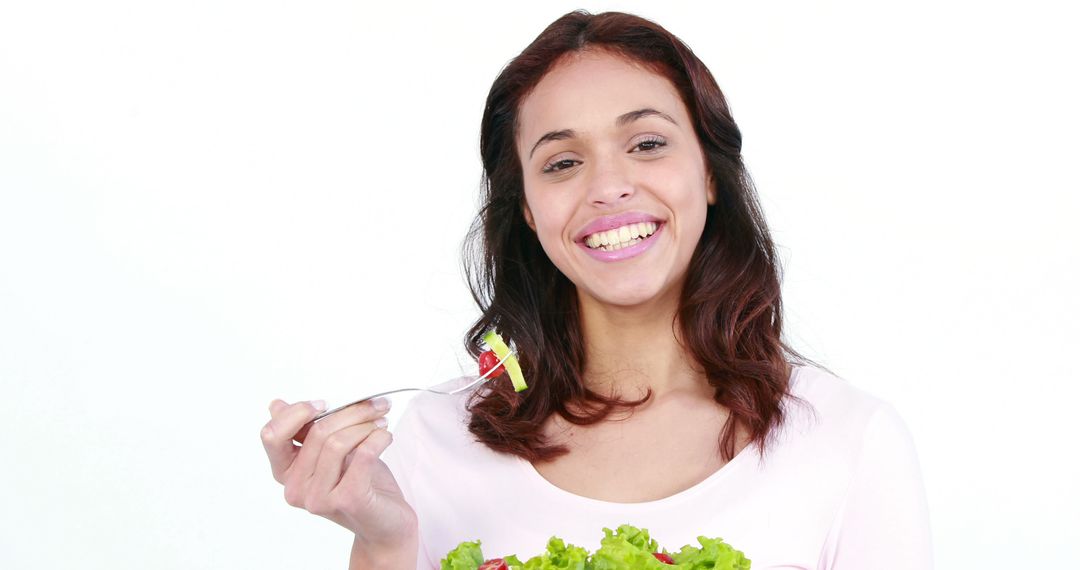 Smiling Woman Eating Fresh Salad and Promoting Healthy Lifestyle - Free Images, Stock Photos and Pictures on Pikwizard.com