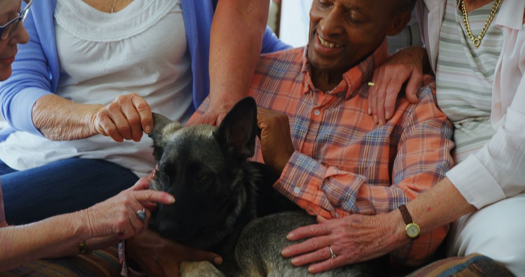 Elderly Man Enjoying Time with Therapy Dog in Group Setting - Free Images, Stock Photos and Pictures on Pikwizard.com