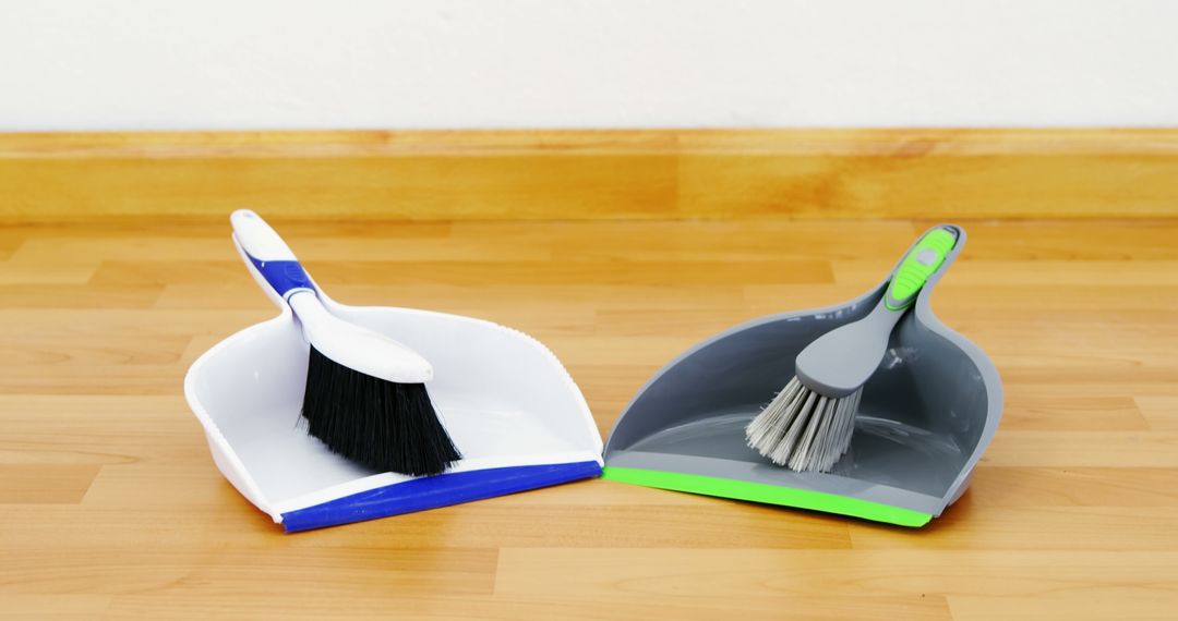 Closeup of Two Dustpan and Brush Sets on Wooden Floor - Free Images, Stock Photos and Pictures on Pikwizard.com