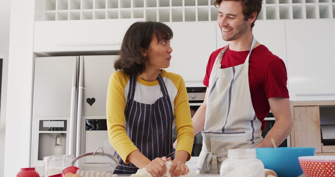 Image of happy diverse couple baking together in kitchen - Free Images, Stock Photos and Pictures on Pikwizard.com