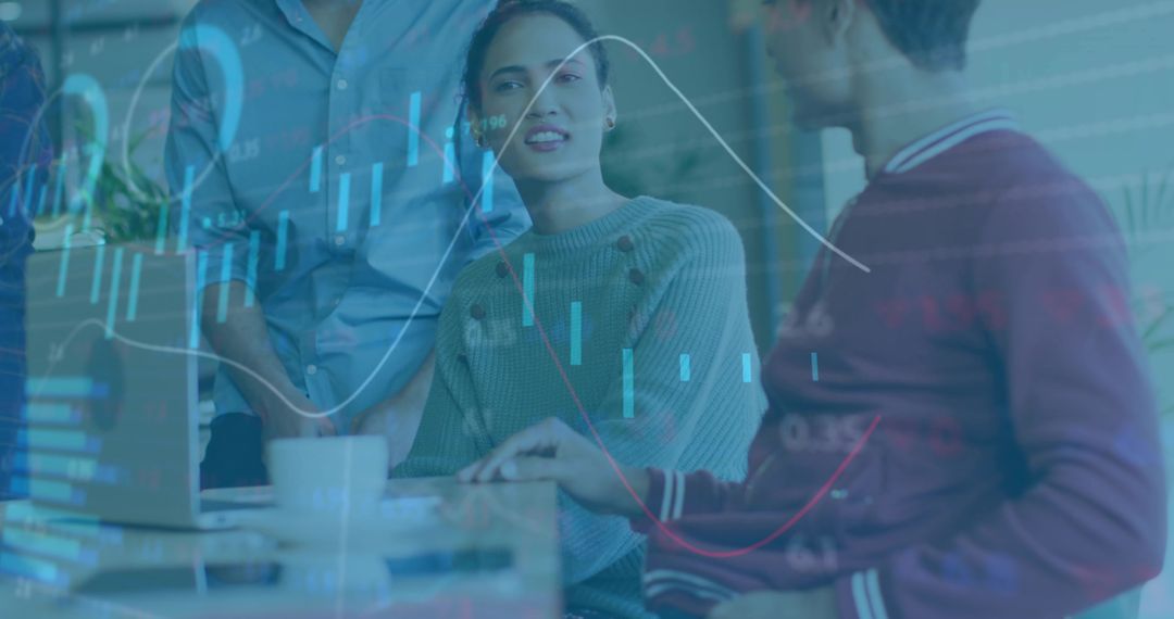 Team collaborating over data visualization with candlestick graphs and laptop