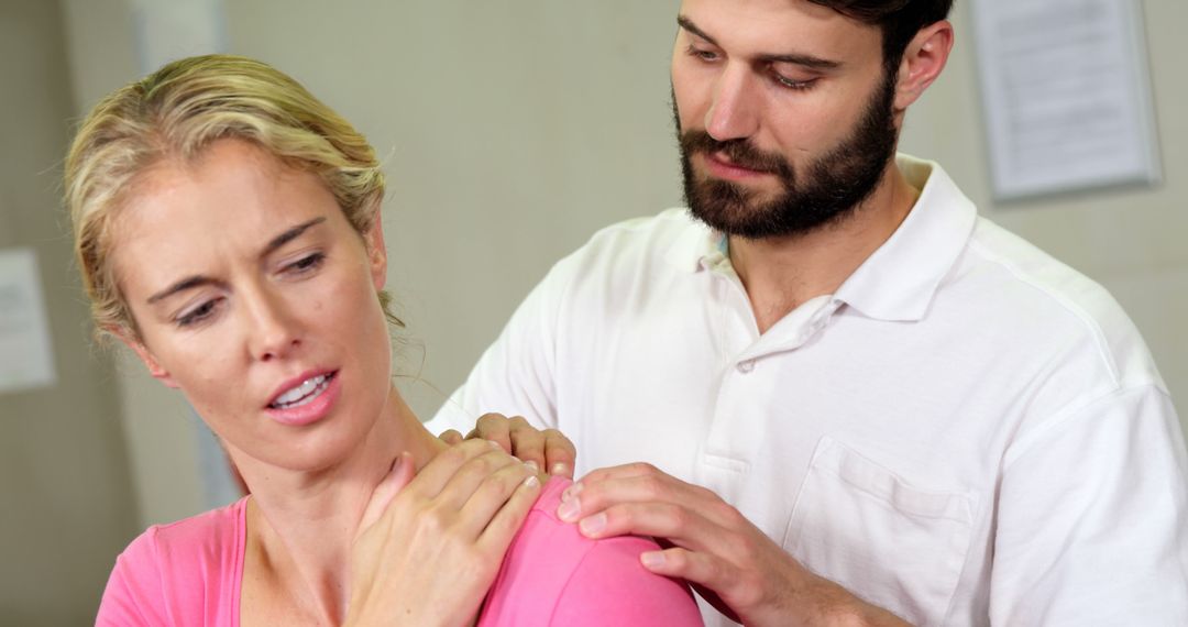 Physical Therapist Treating Female Patient with Shoulder Pain - Free Images, Stock Photos and Pictures on Pikwizard.com