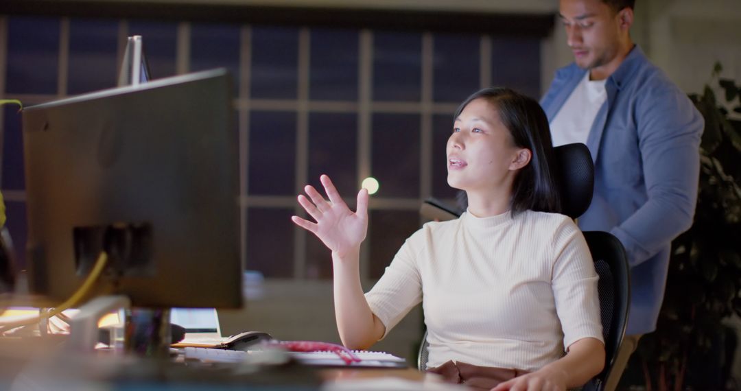 Colleagues Collaborating on Project Late at Night in Office