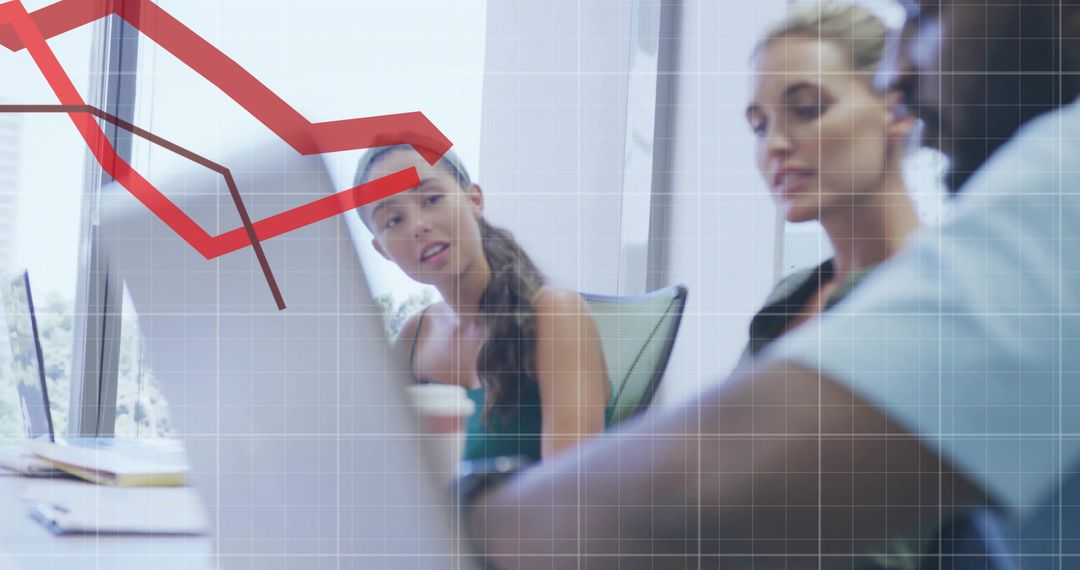 Colleagues Analyzing Graph Trends During Strategy Meeting