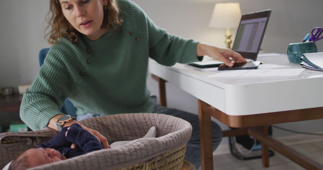 Image of caucasian mother working on laptop from home with newborn baby - Free Images, Stock Photos and Pictures on Pikwizard.com