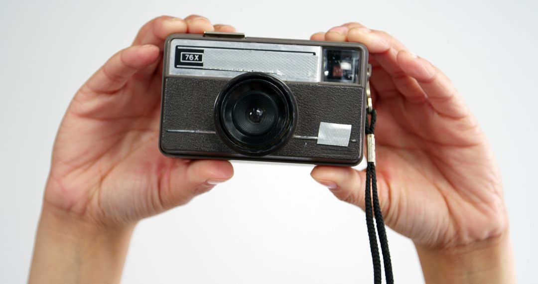 Person Holding Vintage Camera with Both Hands - Free Images, Stock Photos and Pictures on Pikwizard.com