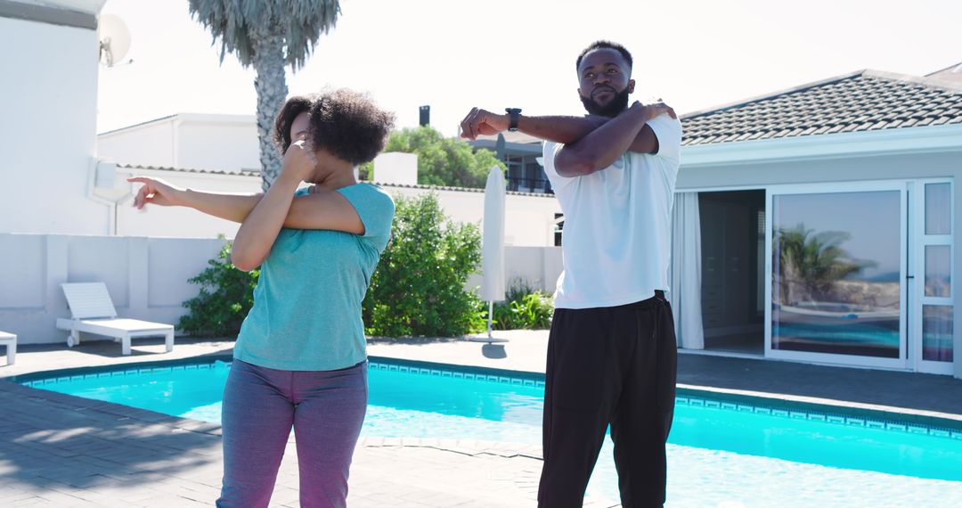 Couple Stretching by Pool on Sunlit Patio Practicing Morning Fitness and Wellness Routine