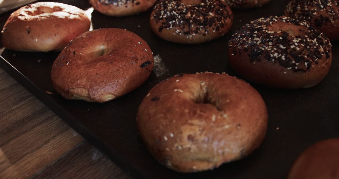 Freshly Baked Bagels Assorted Flavors on Wooden Table - Free Images, Stock Photos and Pictures on Pikwizard.com